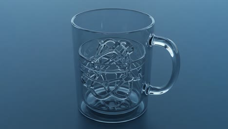 a clear glass mug containing intricate metal twists, showcasing the blend of transparency and complexity in a thought-provoking design sequence