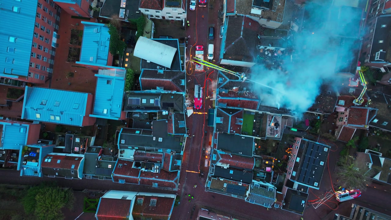 Utrecht Aerial Top down Drone View Over Historic Center Following Gas Explosion and Fires, smoking city centre, Netherlands, firefighter extinguishing fire from fire brigade crane