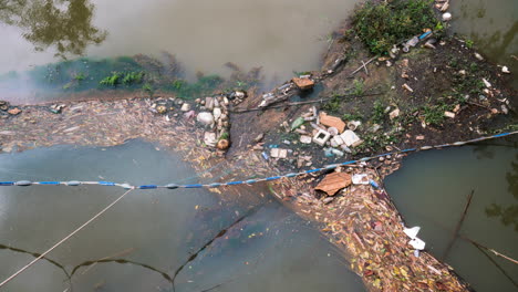 Garbage-waterway-net-trap-strapped-across-a-river