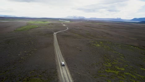 drone rastreando un jeep en el terreno accidentado de islandia