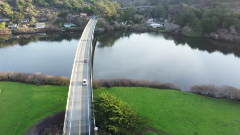 Aerial-view-of-cars-driving-across-a-river-bridge