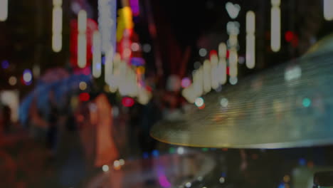 pedestrians walking along neon-lit street, drum cymbal spinning with animated music data visuals