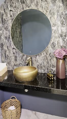 elegant vanity with marbled surfaces and gold sink, vertical