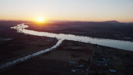 A-helicopter-ride-over-a-river-at-sunset-in-Canada,-BC