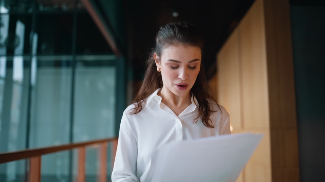 Excited entrepreneur reading documents walking office closeup. Emotional woman