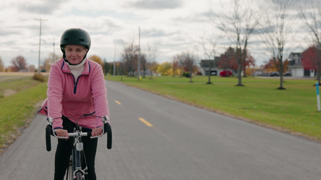Woman Cycling on Road