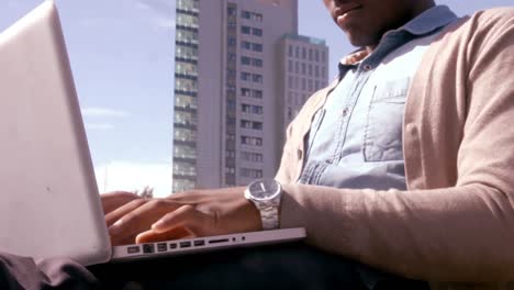 sitting man using laptop