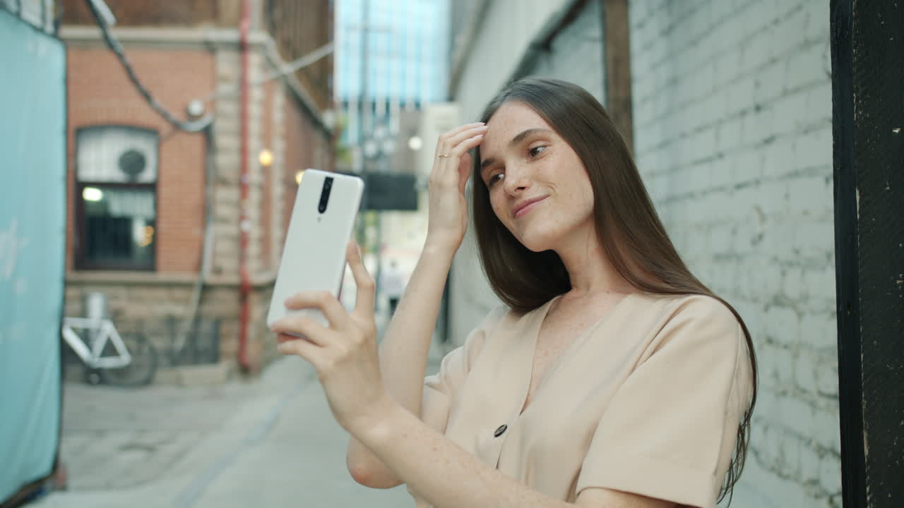 Woman Taking Selfie in a City Alley