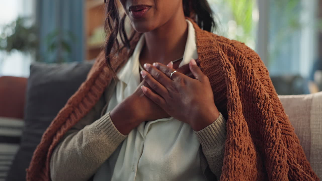 A woman expressing gratitude with her hands on her chest