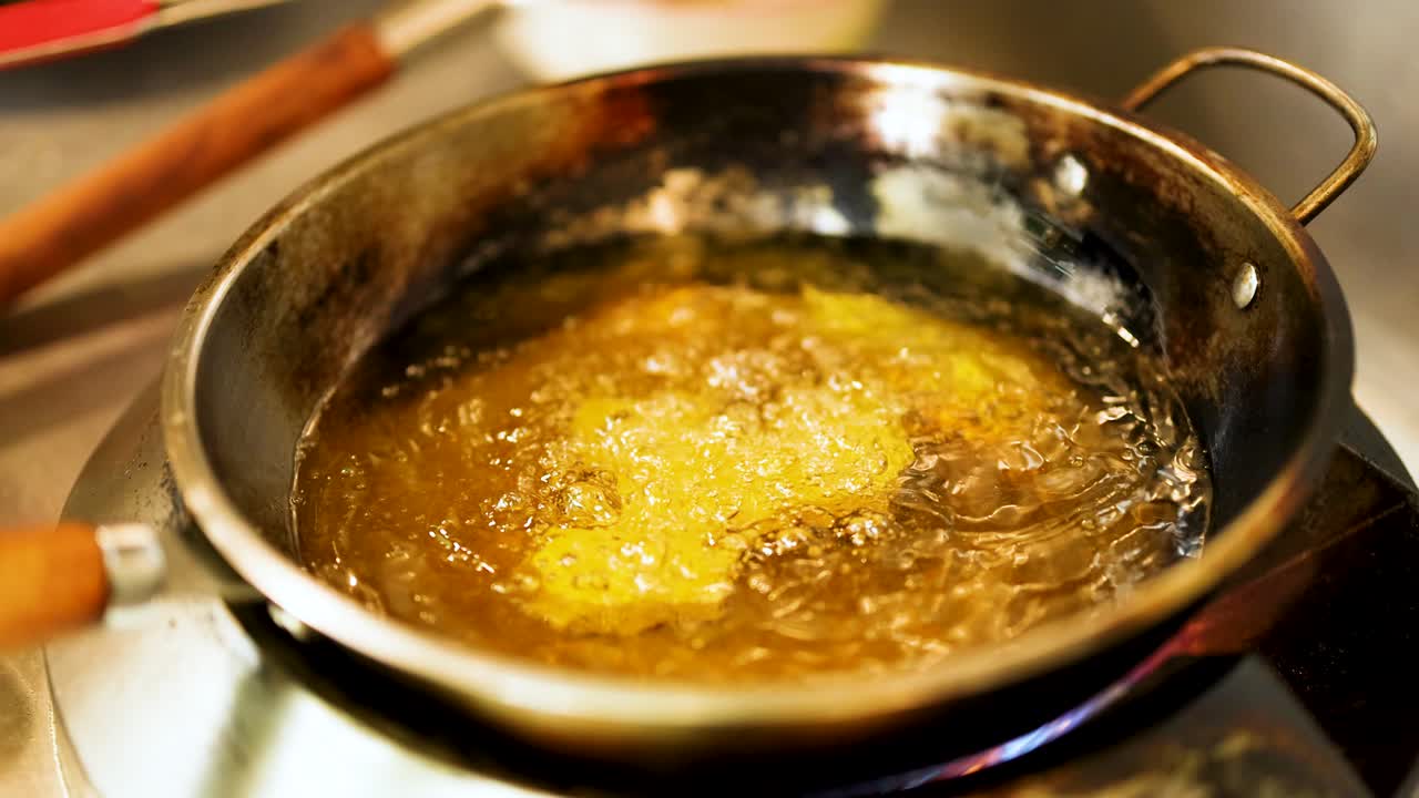 Food frying in hot oil in a pan