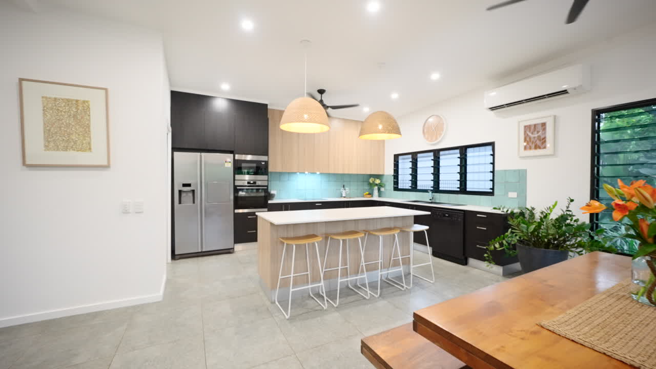 Modern contemporary interior kitchen with grey tiles island Bech top abundance of natural light