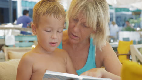 child with grandmother and book