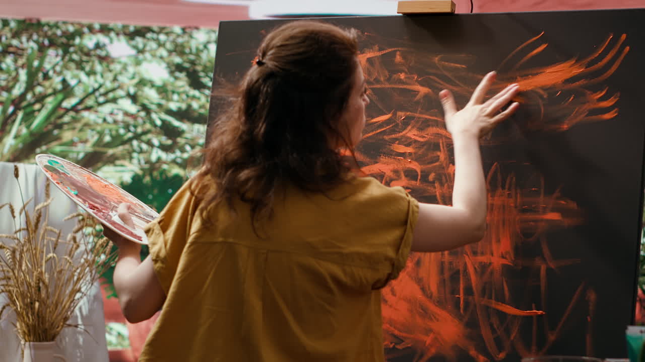 Woman creating abstract painting