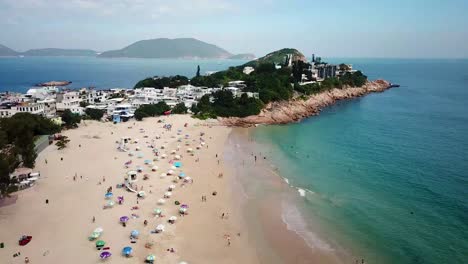 a moving aerial view of visitors using umbrellas at the shek o beach in hong kong as public beaches reopening, after months of closure amid coronavirus outbreak, to the public