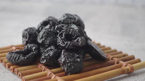 dried plums on a bamboo mat