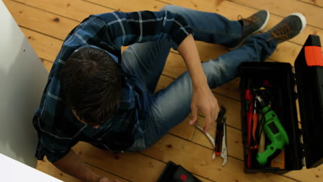 Plumber-is-looking-for-his-wrench-in-his-tools-box