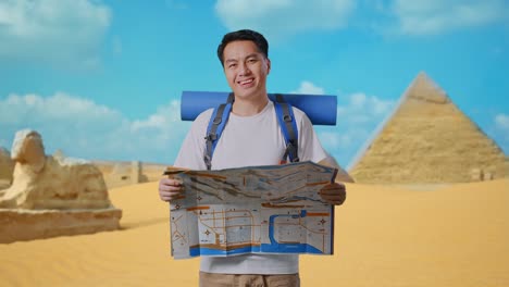 asian male hiker with mountaineering backpack looking at the map then smiling to camera while traveling in pyramid of giza