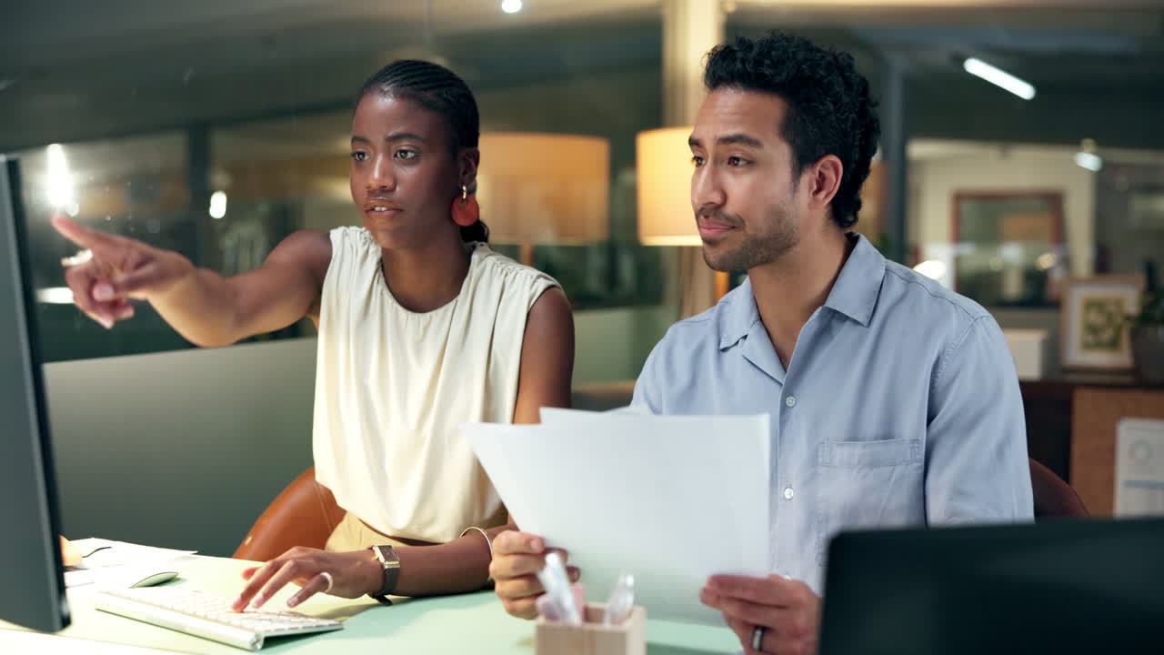 Diverse Colleagues Collaborating on a Project in a Modern Office at Night