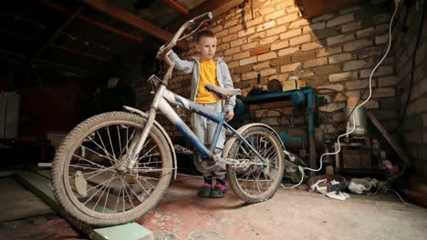 a kid admires the forgotten vintage bicycle. old-fashioned cycle. nostalgia.