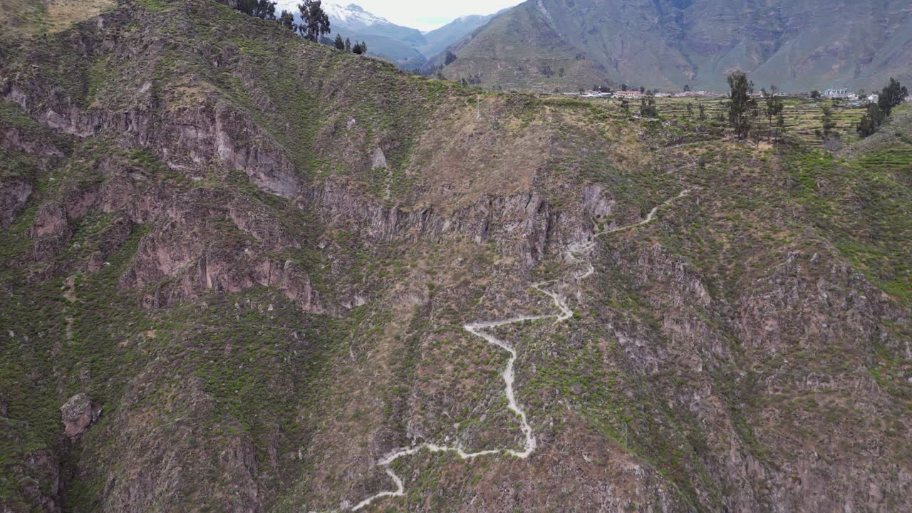 Aerial: Switchback footpath trail leads into steep Colca Canyon, Peru