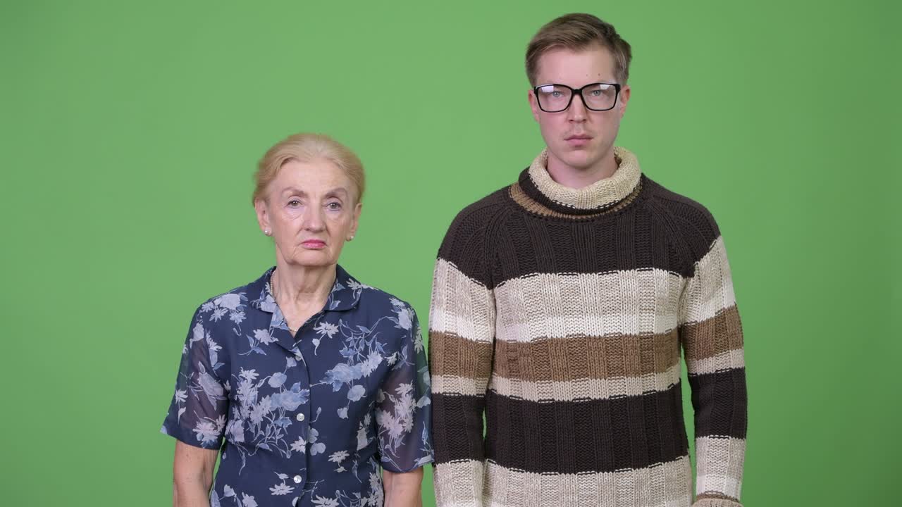 Grandmother and grandson together against green background
