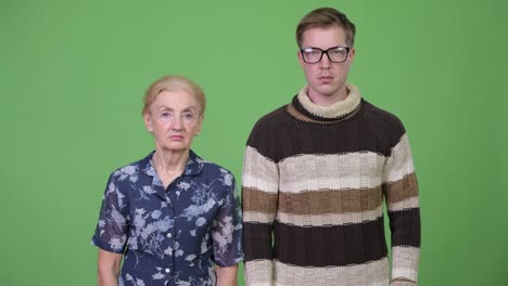 grandmother and grandson together against green background