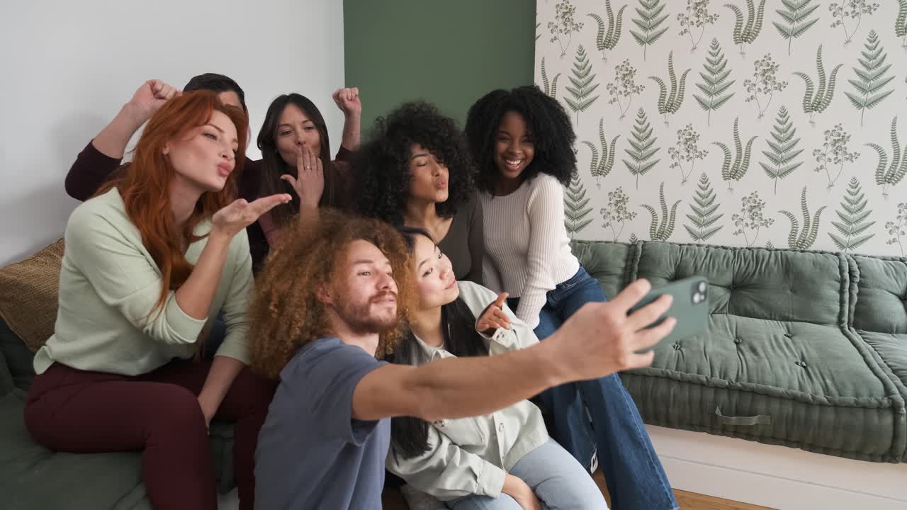 Happy diverse friends taking self-portraits at home