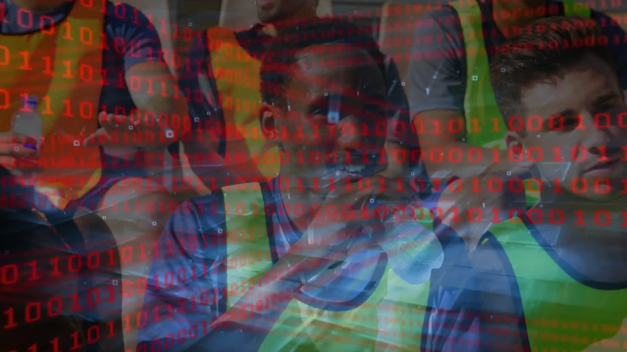 Sports team huddling in tech training wearing neon bibs using phone with floating binary code