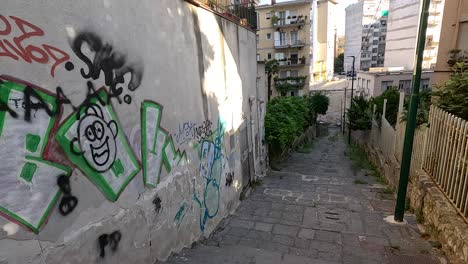 graffiti-covered wall in a narrow naples alley