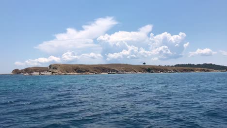 Sailing-and-passing-by-scenic-uninhabited-Greek-islet-on-Mediterranean-sea-in-Sithonia-in-4k