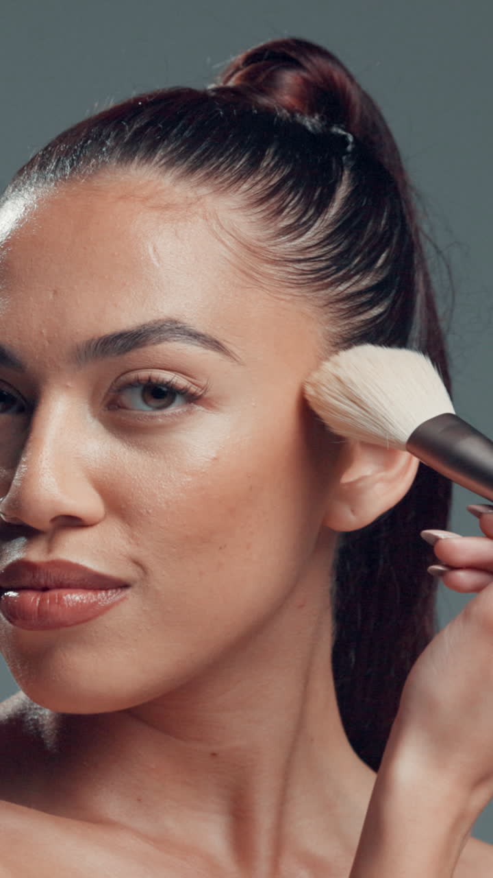 Young Woman Applying Makeup with a Brush to Her Face
