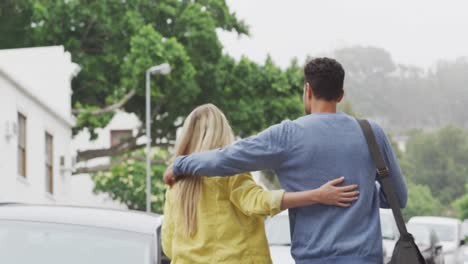 rear view of caucasian couple on the go during coronavirus pandemic