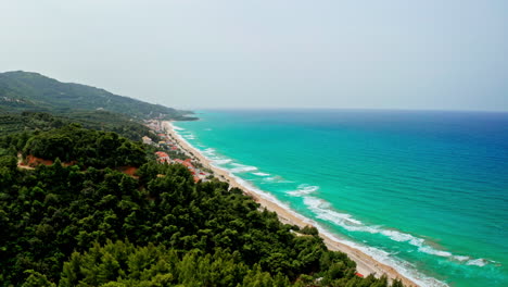 aerial view of a picturesque coastline with turquoise waters, beach, and lush forests