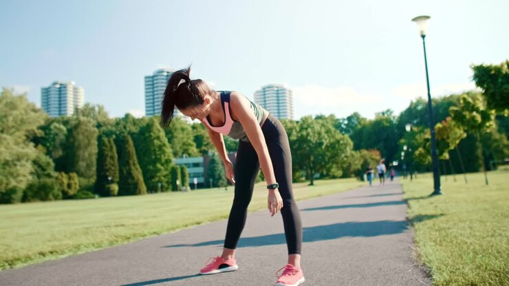 Young woman warming up before jogging, Katowice, Poland