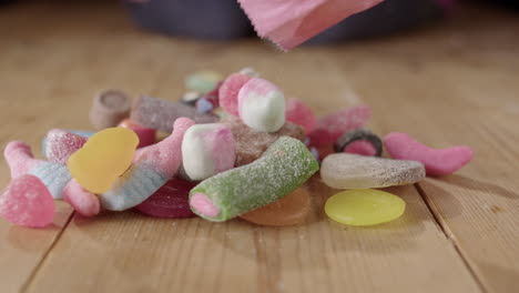 sugary assortment of sweet jelly candies dumped onto table, kids obesity concept