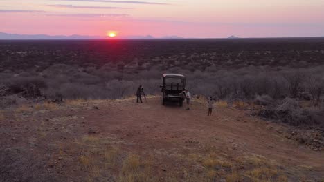 aerial of tourists enjoying a sunset on a safari jeep at the vast and beautiful erindi game preserve namibia