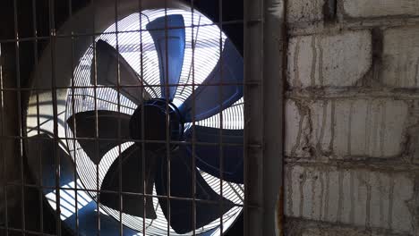 big industrial fan in a white brick wall of a plant. ventilation of factory building. video background with copy space