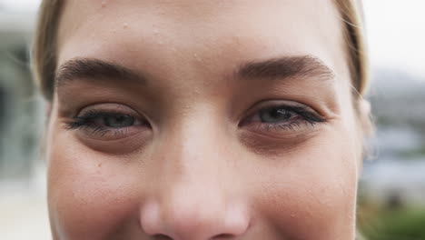 Portrait-of-close-up-of-smiling-caucasian-nurse-on-balcony-with-copy-space,-slow-motion