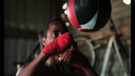 African-American-male-boxer-practicing-boxing-in-fitness-studio-4k