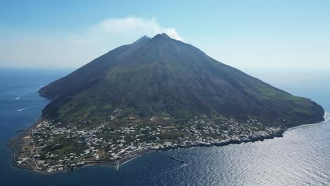 stromboli volcano island village and active smokes at aeolian islands, italy - aerial 4k