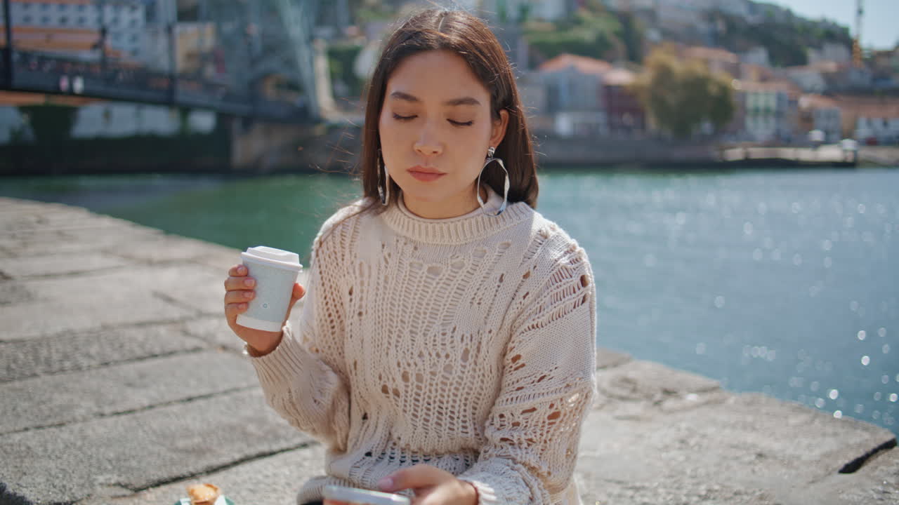 Calm freelancer texting cellphone at sunny river promenade closeup. Work break