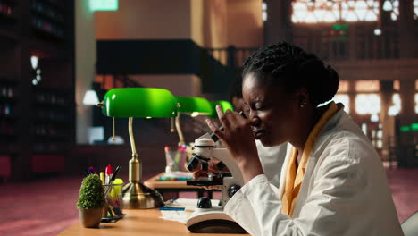 female student working with a microscope to prepare for microbiology lessons