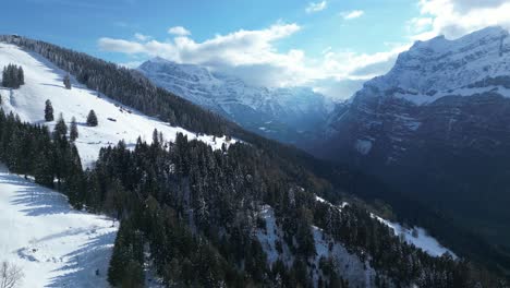 Drone-shot-of-Fronalpstock-mountains-with-beautiful-skyscape-at-background-in-Glarus,-Switzerland