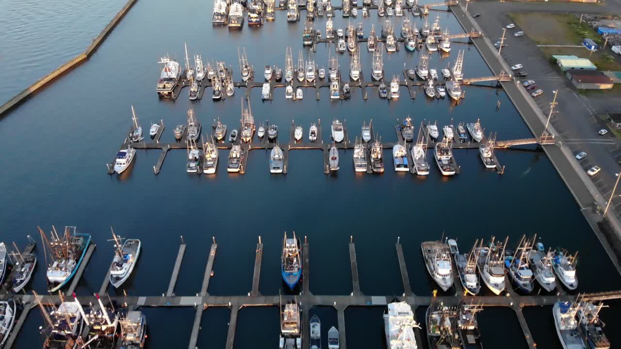 Aerial minimalist footage of harbor with fisherman boat sail boat and luxury yacht moored at the port