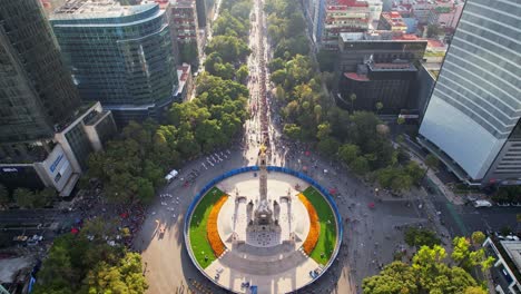 aerial view of a large public gathering at el ángel de la independencia monument on paseo de la reforma, mexico city