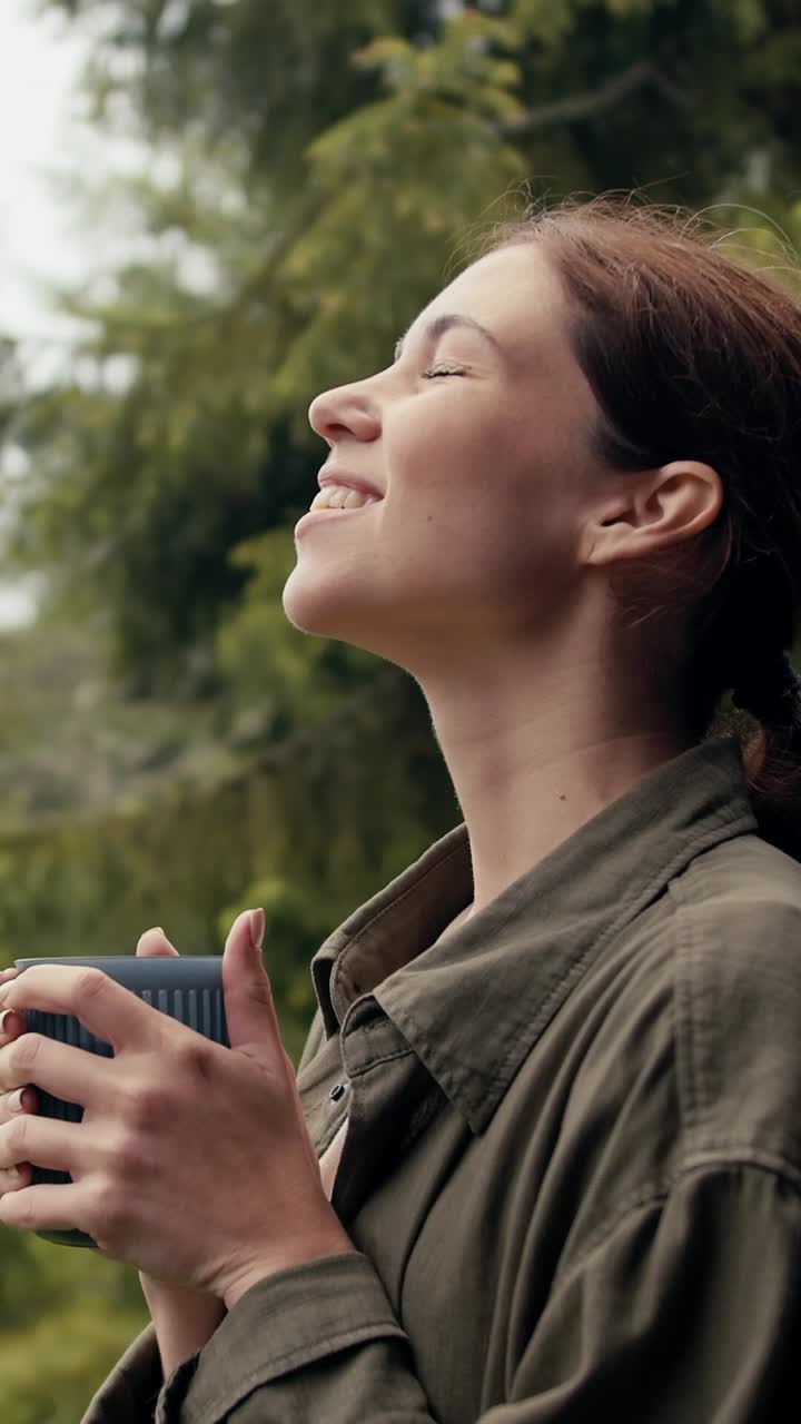 Woman enjoying a drink outdoors in nature
