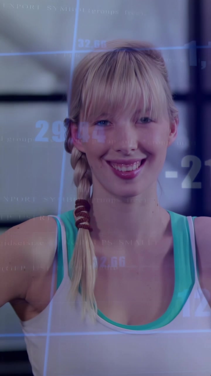 Vertical video: Female athlete warming up by raising arms in gym, HUD responding and showing charts