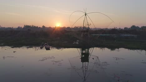 sunrise over a lake with fishing nets