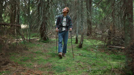 guy trekking in woods at summer. male traveler hiking in fairytale forest