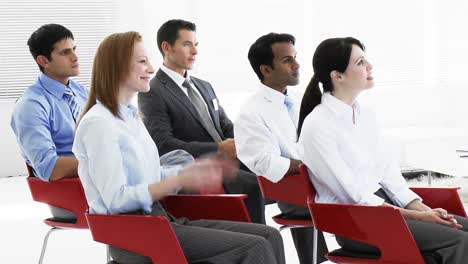 Business-people-applauding-in-a-seminar